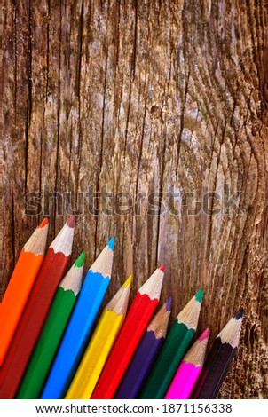 color pencils on the wooden background, pencil on wooden board