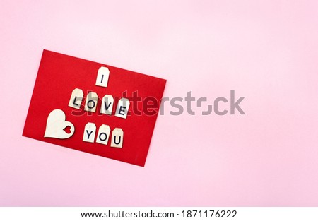 Valentines day layout lettering red envelop with wooden letters on pink background with copy spase