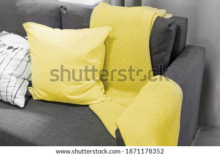 Color of the year 2021. blanket and pillows on the sofa in the interior Royalty-Free Stock Photo #1871178352