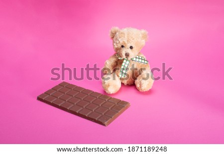 bear and milk chocolate on pink background