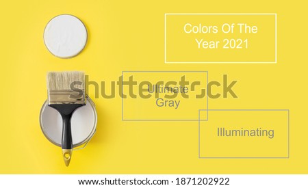 Brush with open paint on yellow. Trendy color Ultimate Grey and Illuminating of the 2021 year. Modern design.