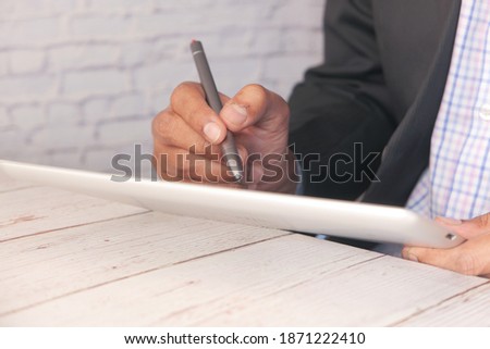 businessman using digital tablet on office desk 