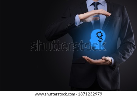 Businessman man holding a man icon with gears in his head. Artificial intelligence. Technology advances. Robot. Contour symbol Royalty-Free Stock Photo #1871232979