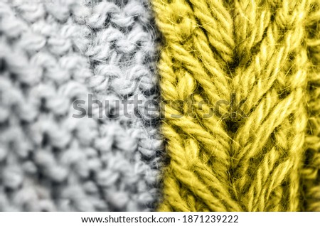 Knitted texture. Demonstrating trendy Color of the Year 2021. Illuminating Yellow and Ultimate Gray. Duotone pattern fabric made of wool. Color Psychology. Depression treatment.