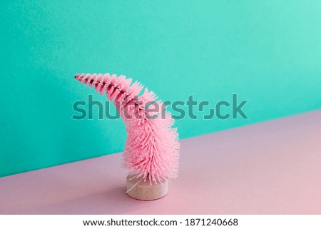 Light pink Christmas tree against pastel two-tone background. Minimal creative trendy New Year concept. Copy space.