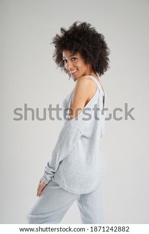 Beautiful black girl in a photo Studio, posing in cashmere clothes