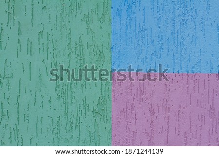 Colorful (green, blue and purple) painted decorative wall as background, texture