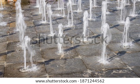 Close-up of porous fountain on city square