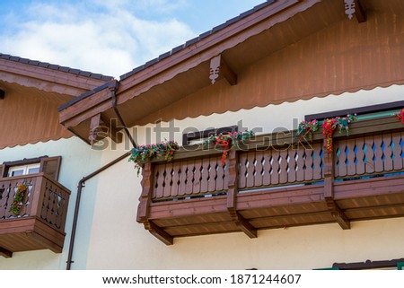 Partial close-up of balcony window of colorful building in European town