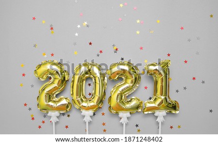 Balloons symbols 2021 with glitters on festive background.