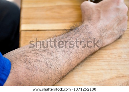 man's hairy arm, soft focus