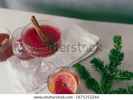 Mulled wine Christmas holiday red beautiful festive moody dark grainy pictures with stylish decoration pine trees minimalism long shot