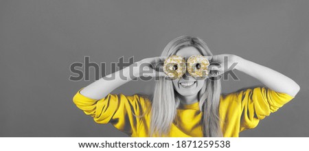 Abstract portrait in duotone colors of woman with donuts