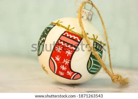 White Christmas ball with an image of socks for presents, white background