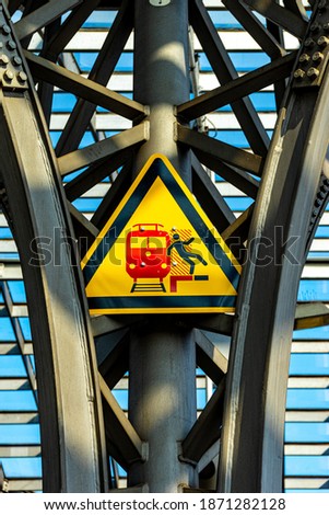 A vertical shot of a historical railway station warning sign in Cologne, Germany