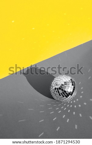 Disco ball with background in trending colors of 2021 - gray and yellow.