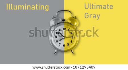 Old alarm clock in trendy 2021 new colors. Creative flat lay vintage clock on color background. Illuminating Yellow and Ultimate Gray. Color of the Year 2021.
