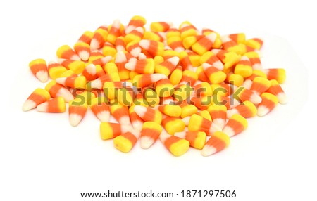 Candy corn in jar on white background