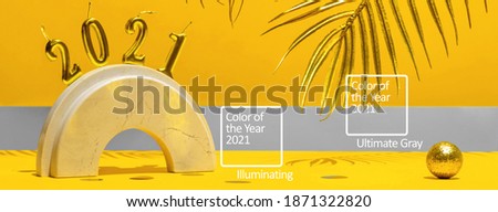 Golden candles with the new year 2021 on the marble arch, palm leaves, confetti on a yellow background with the horizon. Festive trend still life.