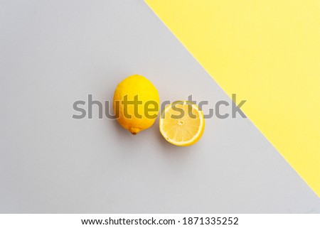 abstract modern handmade paper background with lemon fruits in ultimate gray and illuminating yellow colors