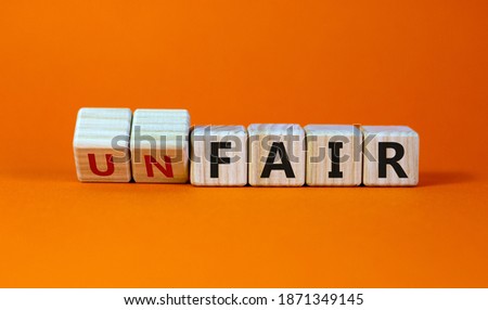 Fair or unfair symbol. Turned a cube and changes words 'unfair' to 'fair'. Beautiful orange background. Business and fair or unfair concept. Royalty-Free Stock Photo #1871349145
