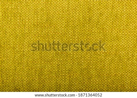 Factory fabric with brown and yellow threads interspersed. Close-up long and wide texture of natural fabric. Fabric texture of natural cotton or linen textile material