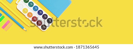 School and university supplies on Illuminating yellow background. Flat lay, top view, copy space. 