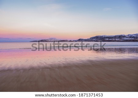 Arctic beach in Teriberka. Wonderful Arctic sunset landscape on the Barents sea.