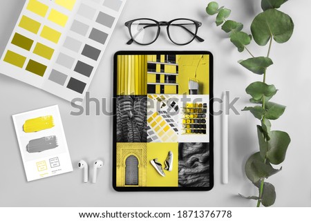 iPad pro on the table on screen Collage Illuminating and Ultimate gray Pantone color of the year 2021 Royalty-Free Stock Photo #1871376778