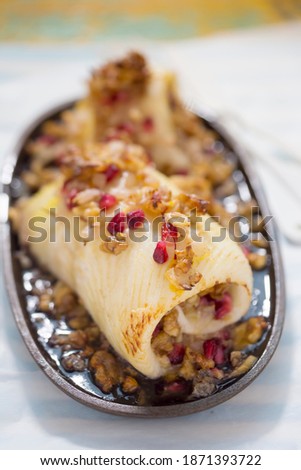 Halibut fish roulades with pomegranate and wallnuts