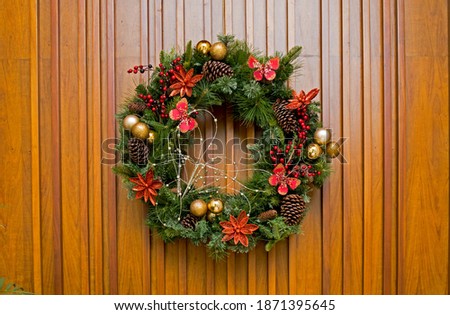 picture of a decorated advent wreath, on wooden background. symbol of hope and faith 