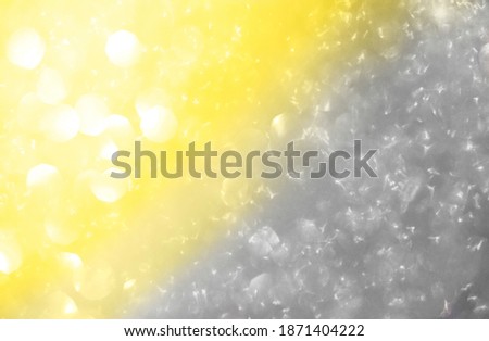 Abstract background of bright spots of lights shining with illuminating yellow and ultimate gray colors