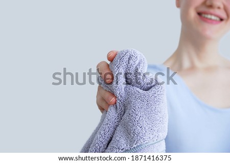 Smiling caucasian woman holding a rag for cleaning the house.