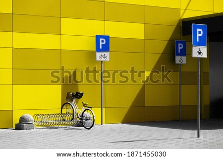 bike and bicycle parking signs against wall background. Illuminating and Ultimate gray color of the year 2021.
