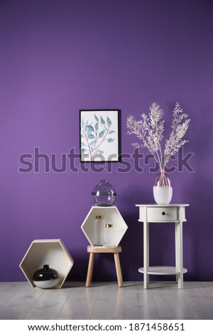 Composition with elegant vases near purple wall