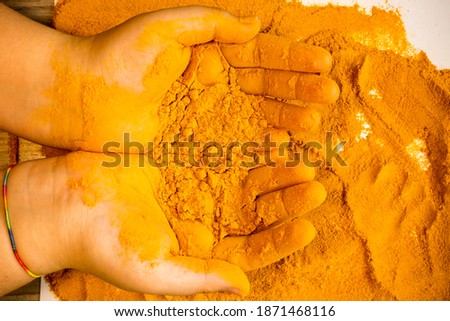 Macro detail shot of turmeric presented in palm yellow mustard yellow spice abstract pastel interesting different different yellow background images buying
