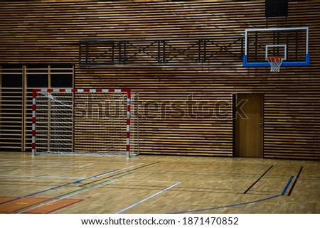 basketball hoop and handball goal in a modern school gym