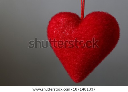 Red heart on a gray background.