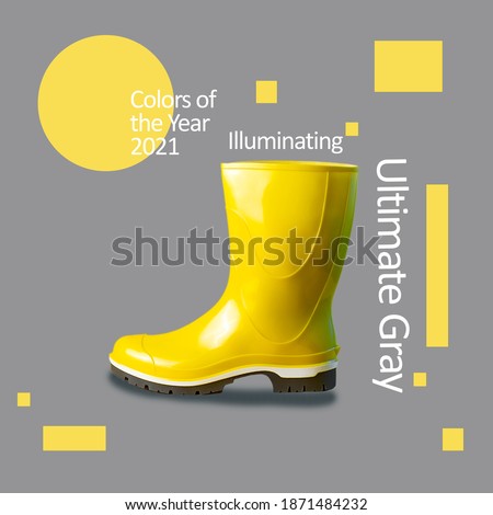 Bright yellow rubber boot against the same color. A minimalist concept on the theme of color 2021