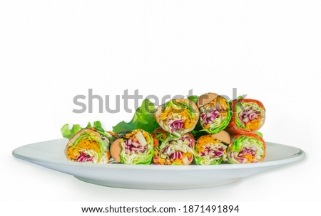 A picture of a salad rolled on a plate and a white background