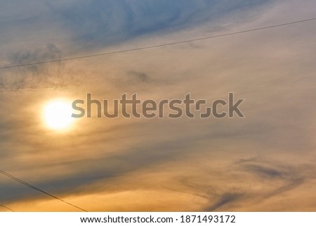 Sun illuminates feather clouds. general plan. day light. color