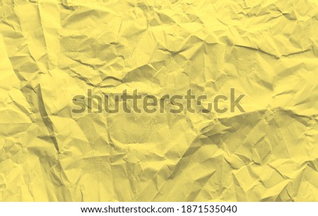Crumpled yellow and gray paper, texture for the background and copy space. Color of the year 2021.