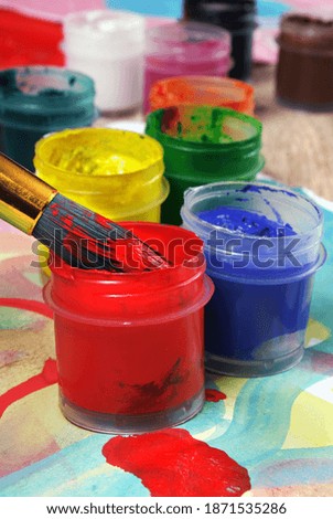 Bright colorful paints and brush. watercolor paints in the artist's studio. selective focus