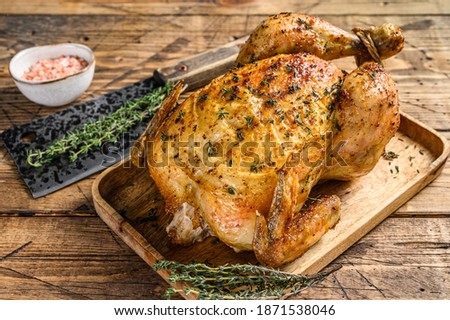 Whole grilled chicken rotisserie. Wooden background. Top view