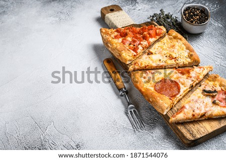 Classic Italian pizza on a wooden cutting board. White background. Top view. Copy space