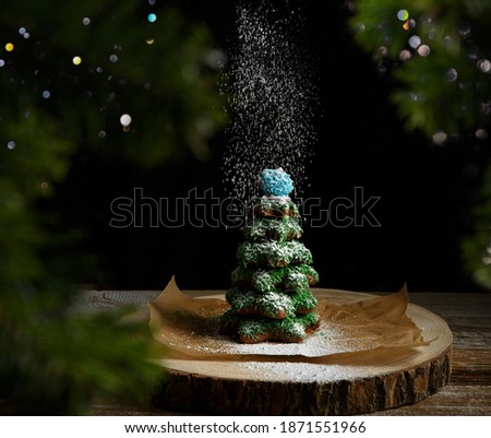Christmas composition. Gingerbread spruce. Christmas wreath. Against the background of blurred festive garlands.selective focus. High quality photo. 