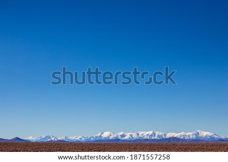 Snowcapped mountain and wide blue sky in the Nevada desert. High quality photo