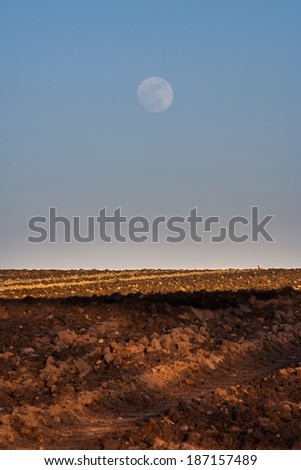 moon over plowed field