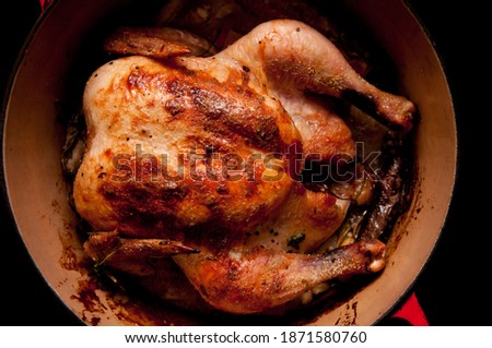 whole roasted chicken in lemongrass and coconut milk, dutch oven Royalty-Free Stock Photo #1871580760