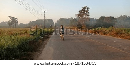 Women riding a bicycle to farm.